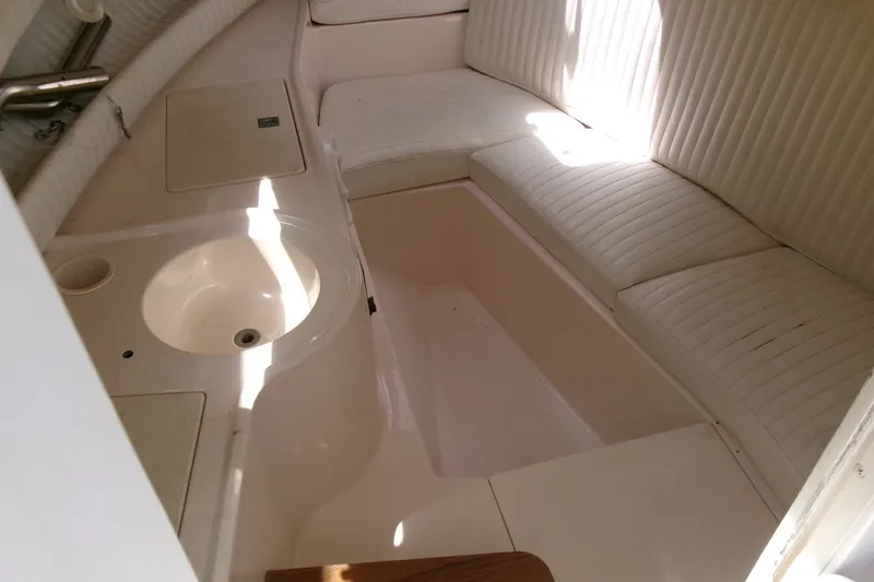 Slide: The Image of 2001 Grady-White Gulfstream 232 cabin interior with seating and sink. - 13