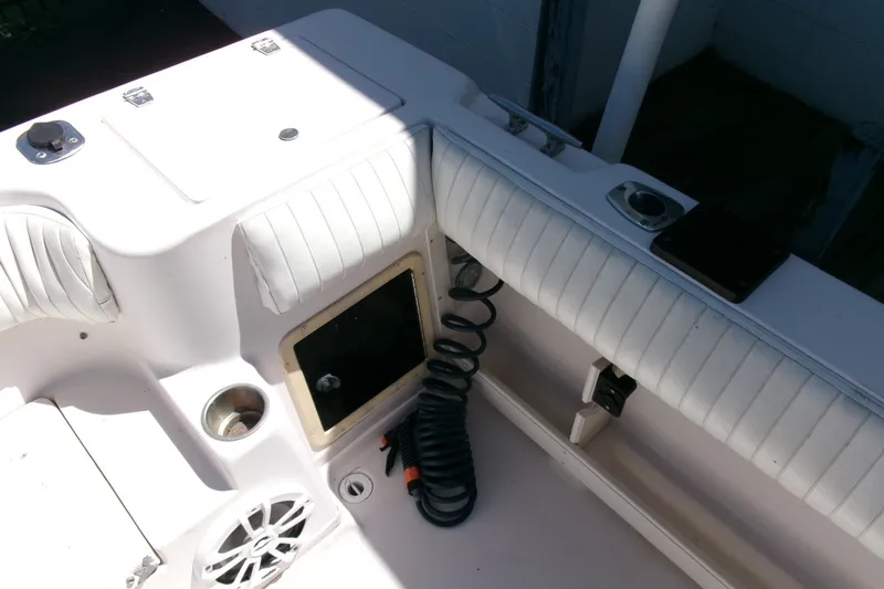 Slide: The Image of 2001 Grady-White Gulfstream 232 boat interior with seating, speaker, and coiled hose. - 25