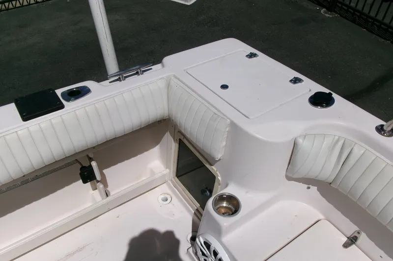 Slide: The Image of 2001 Grady-White Gulfstream 232 boat interior with white cushioned seating and storage compartments. - 26