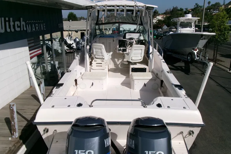 Slide: The Image of 2001 Grady-White Gulfstream 232 boat with dual Yamaha 150 engines at a marina. - 28
