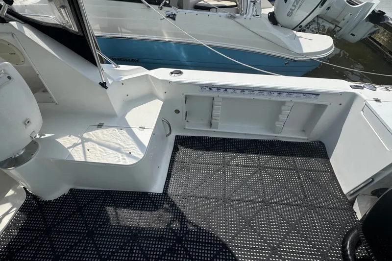 Slide: The Image of 2002 Wellcraft 220 Coastal boat interior with non-slip flooring and seating area. - 4
