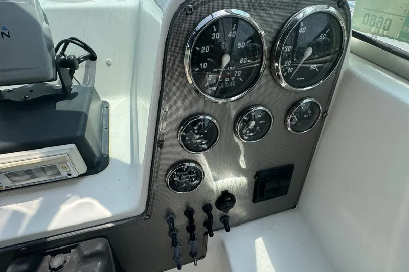 Slide: The Image of Dashboard of a 2002 Wellcraft 220 Coastal boat with gauges and controls. - 9