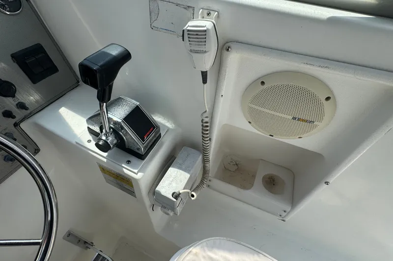 Slide: The Image of Control panel of a 2002 Wellcraft 220 Coastal boat with throttle and speaker. - 11