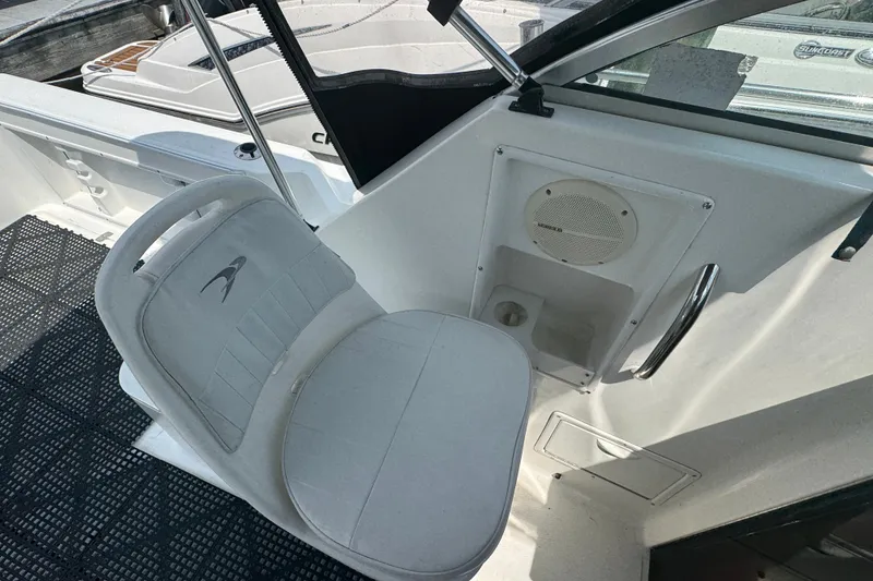 Slide: The Image of 2002 Wellcraft 220 Coastal boat interior with white seating and speaker panel. - 13