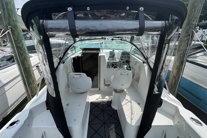 Slide: The Image of 2002 Wellcraft 220 Coastal boat interior with helm, seats, and clear canopy. - 17