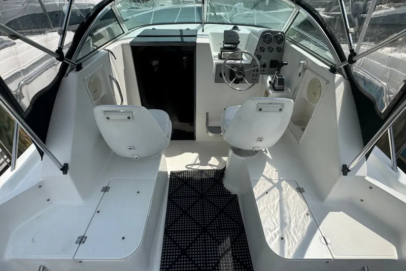 Slide: The Image of 2002 Wellcraft 220 Coastal boat interior with steering wheel and seating. - 5