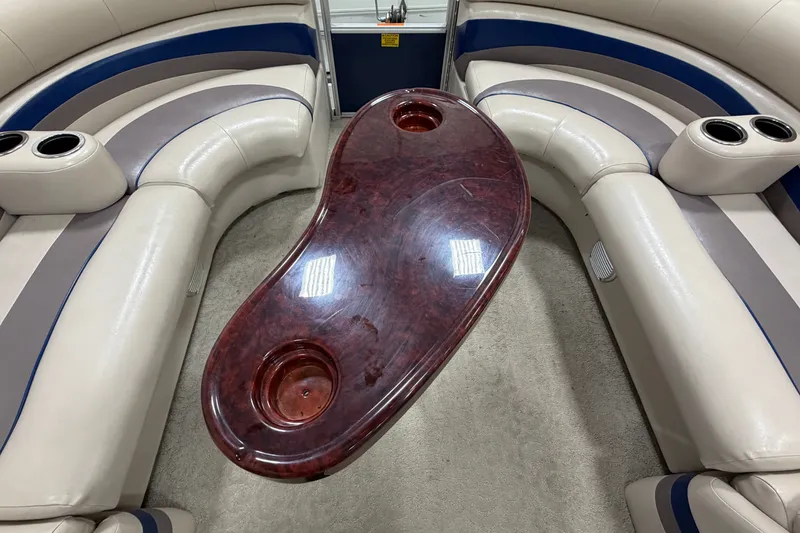 Slide: The Image of Luxurious seating area with a kidney-shaped table on a 2012 South Bay 522 SL boat. - 25