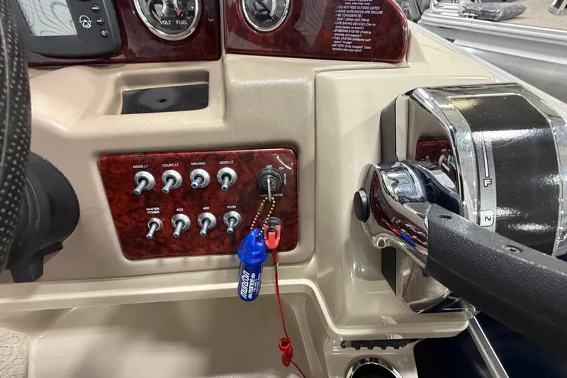 Slide: The Image of Control panel of a 2012 South Bay 522 SL boat with switches and throttle. - 19