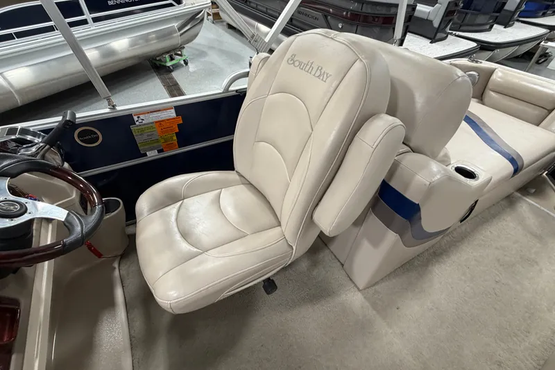 Slide: The Image of Captain's chair in a 2012 South Bay 522 SL pontoon boat, featuring beige upholstery. - 15