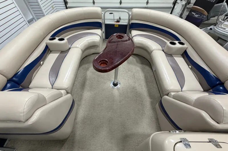 Slide: The Image of Luxurious interior of a 2012 South Bay 522 SL pontoon boat with plush seating and table. - 22