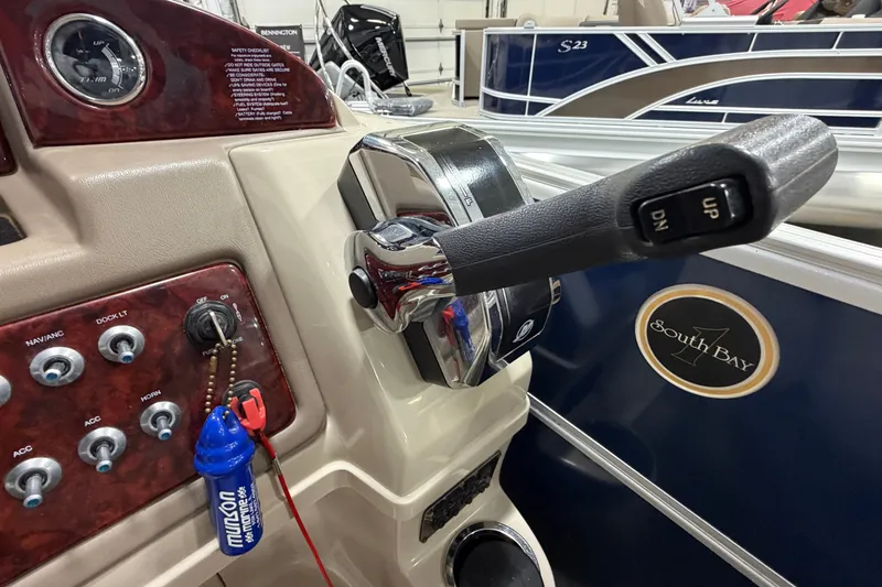 Slide: The Image of Control panel of a 2012 South Bay 522 SL boat with throttle lever and switches. - 20