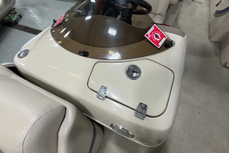 Slide: The Image of 2012 South Bay 522 SL boat console with beige seating and dashboard details. - 26