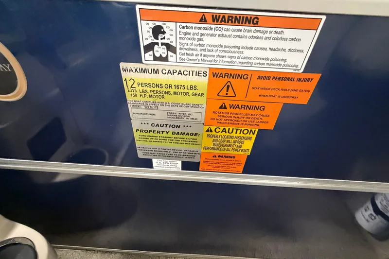 Slide: The Image of Warning labels on a 2012 South Bay 522 SL boat, detailing safety and capacity information. - 16