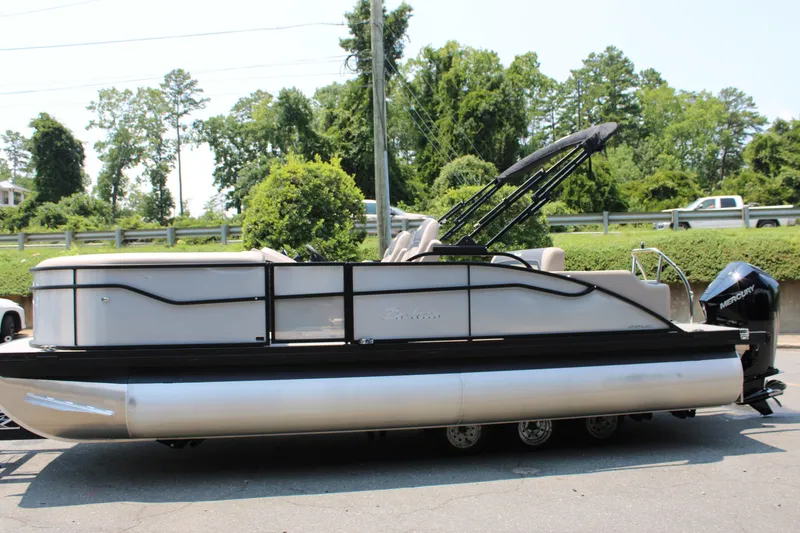 Slide: The Image of 2027 Barletta ARIA 22UC pontoon boat with sleek design, parked outdoors. - 6