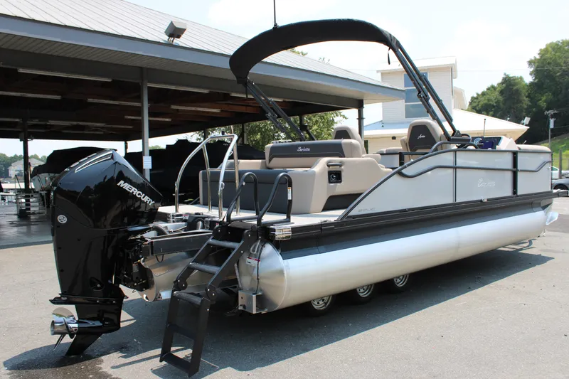 Slide: The Image of 2027 Barletta ARIA 22UC pontoon boat with Mercury engine, docked outdoors. - 3