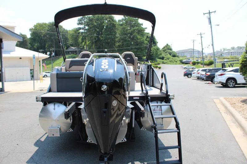 Slide: The Image of 2027 Barletta ARIA 22UC pontoon boat with powerful outboard motor in a parking lot. - 4