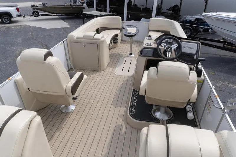 Slide: The Image of 2026 SunCatcher Fusion 324RC pontoon boat interior with beige seating and modern helm. - 9