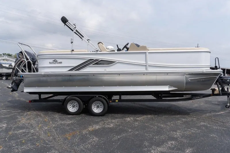 The Image of 2026 SunCatcher Fusion 324RC pontoon boat on trailer, side view. - 1