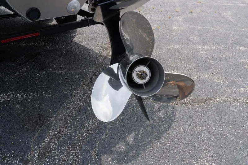 Slide: The Image of Close-up of a 2026 SunCatcher Fusion 324RC boat propeller on pavement. - 7