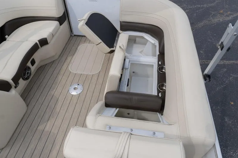 Slide: The Image of Interior of 2026 SunCatcher Fusion 324RC boat with beige seating and storage compartments. - 29