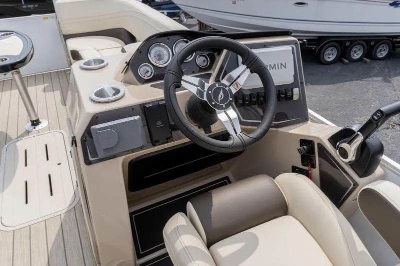 Slide: The Image of Steering console of 2026 SunCatcher Fusion 324RC boat with modern controls and gauges. - 10