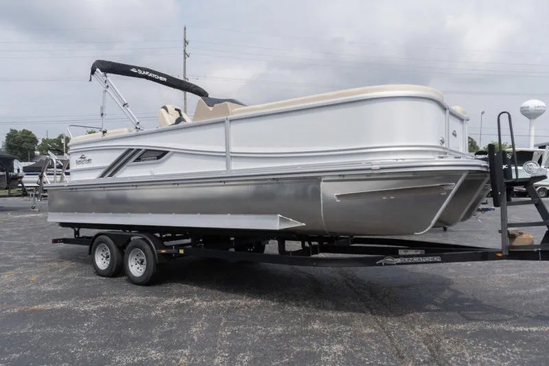 Slide: The Image of 2026 SunCatcher Fusion 324RC pontoon boat on trailer, showcasing sleek design and modern features. - 3