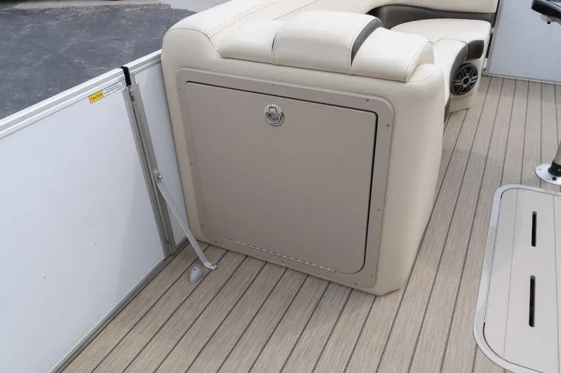 Slide: The Image of 2026 SunCatcher Fusion 324RC boat interior with beige seating and wood-patterned flooring. - 13