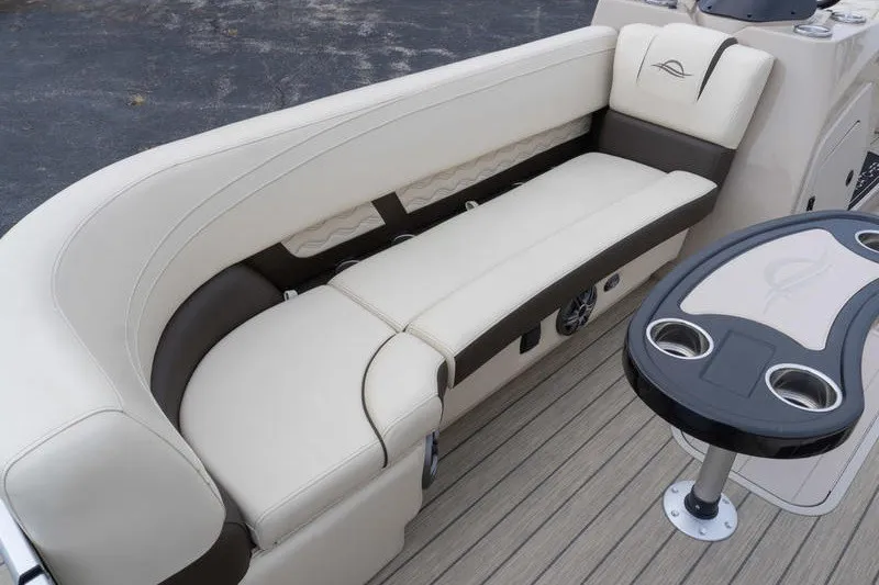 Slide: The Image of Luxurious seating and table on 2026 SunCatcher Fusion 324RC boat, featuring elegant design and cup holders. - 20