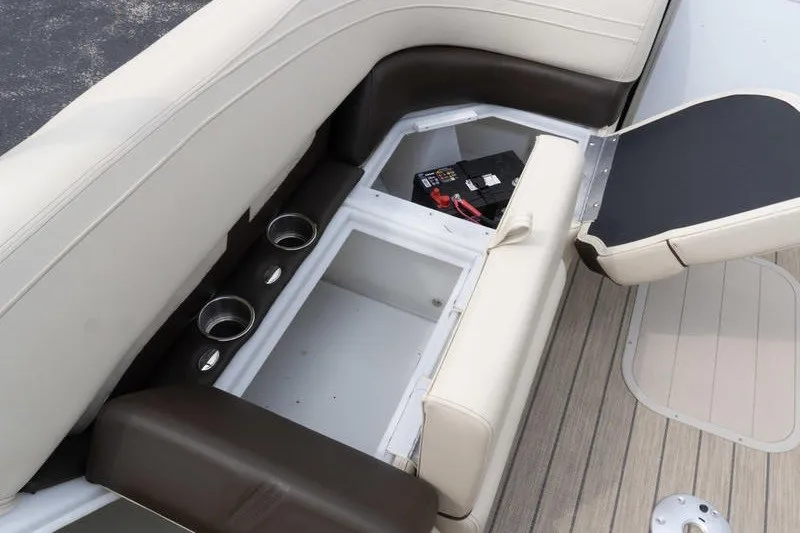 Slide: The Image of 2026 SunCatcher Fusion 324RC boat seating with storage compartment and cup holders. - 27