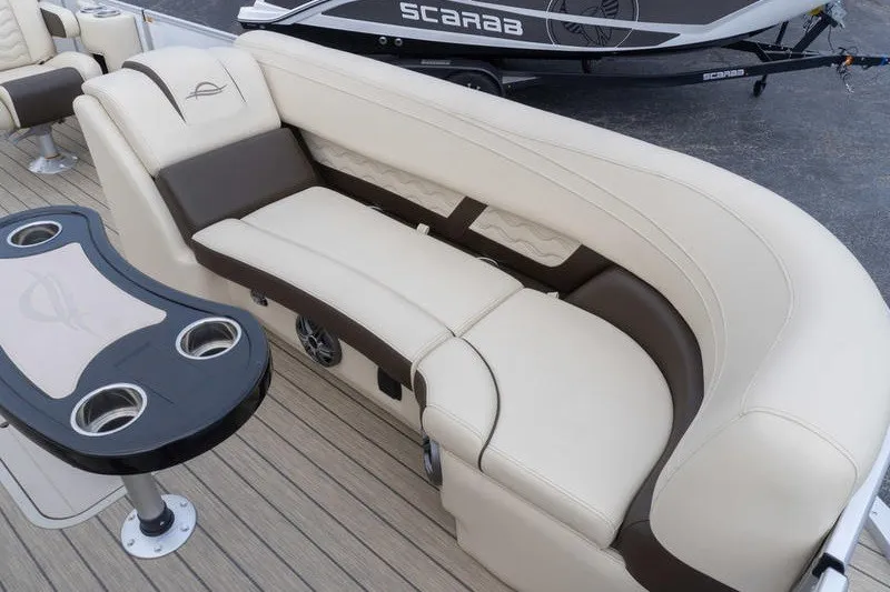 Slide: The Image of Luxurious seating on 2026 SunCatcher Fusion 324RC boat, featuring elegant beige and brown upholstery. - 21