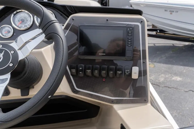 Slide: The Image of Steering console of 2026 SunCatcher Fusion 324RC with Garmin display and control switches. - 12
