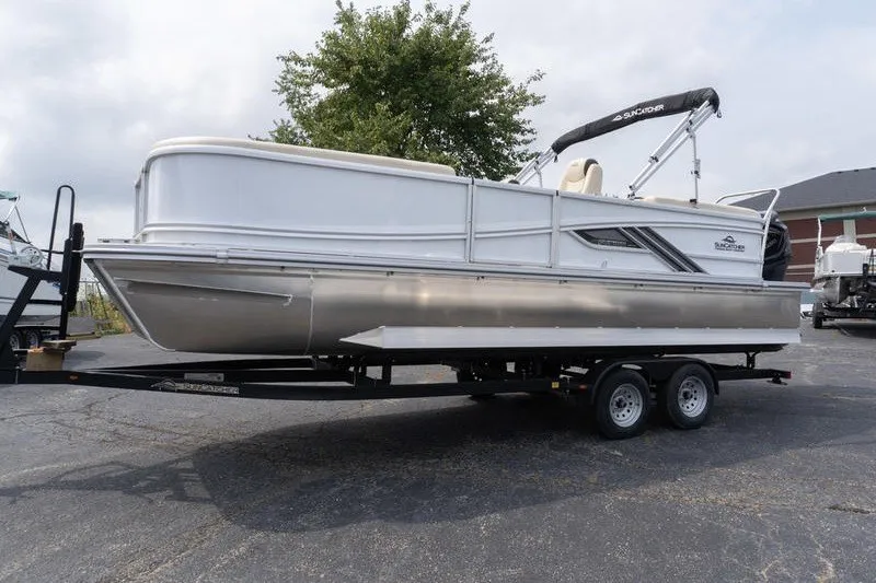Slide: The Image of 2026 SunCatcher Fusion 324RC pontoon boat on trailer, parked outdoors. - 5