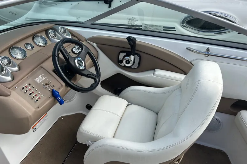 Slide: The Image of 2008 Cobalt 200 boat cockpit with steering wheel, gauges, and white captain's chair. - 18