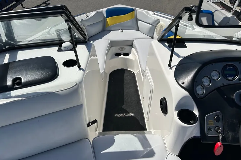Slide: The Image of Interior view of a 2001 Tige 22i boat, featuring seating and dashboard controls. - 7
