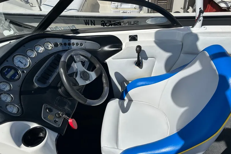 Slide: The Image of Interior of a 2001 Tige 22i boat showing steering wheel and dashboard controls. - 5