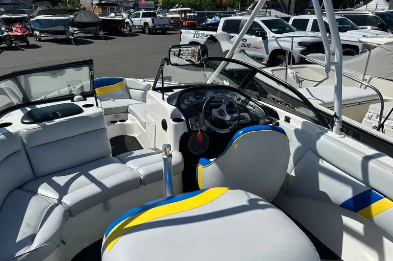 Slide: The Image of Interior of a 2001 Tige 22i boat with white and blue seating. - 10
