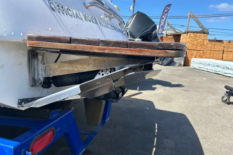 Slide: The Image of Rear view of a 2001 Tige 22i boat on a trailer, showcasing the swim platform. - 22