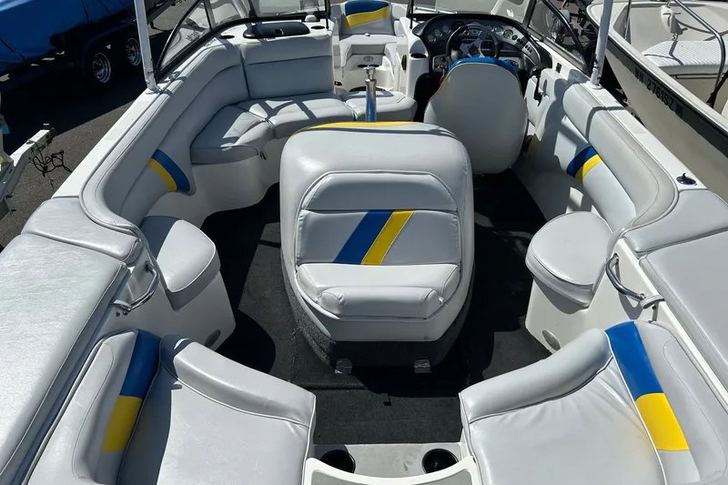 Slide: The Image of 2001 Tige 22i boat interior with white, blue, and yellow seating. - 9