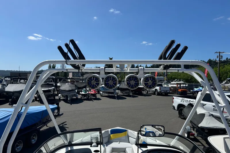Slide: The Image of 2001 Tige 22i boat with wakeboard tower and speakers, parked in a marina. - 2