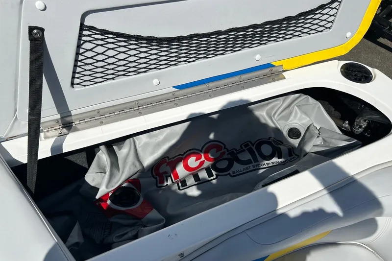 Slide: The Image of Open storage compartment in a 2001 Tige 22i boat with a Free Motion ballast bag. - 15