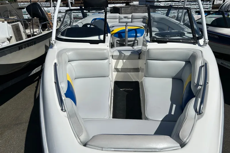 Slide: The Image of 2001 Tige 22i boat interior with gray and blue seating, open bow design. - 6