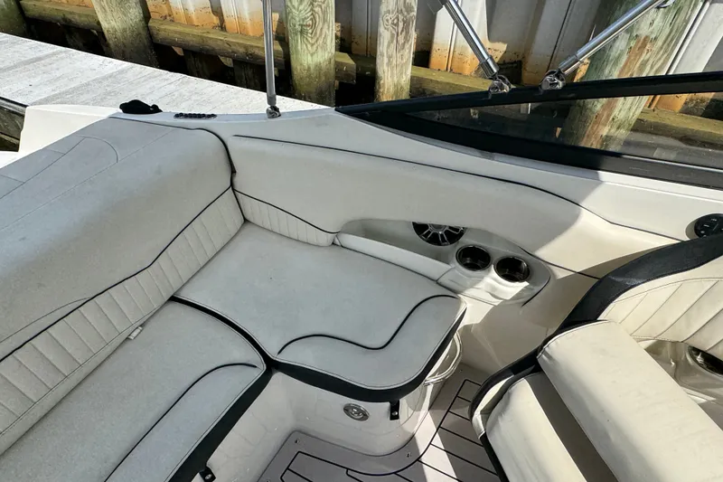 Slide: The Image of Interior of a 2021 Stingray 214 LR boat with white seating and cup holders. - 23
