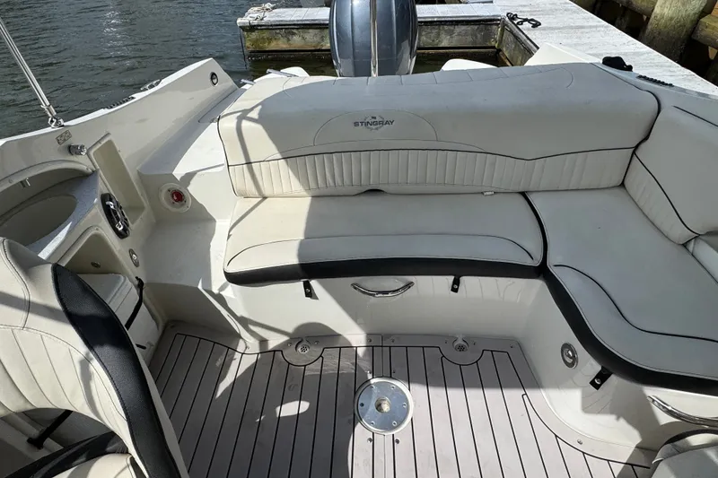 Slide: The Image of 2021 Stingray 214 LR boat interior with white seating and sleek design. - 22