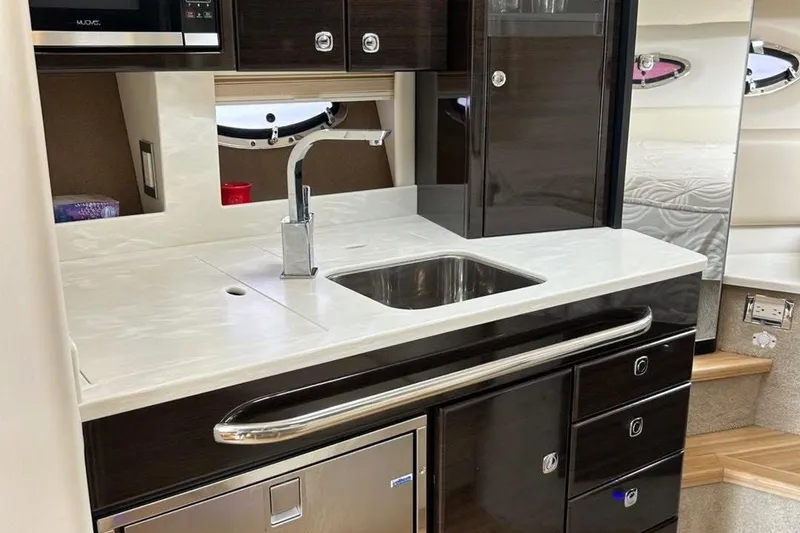Slide: The Image of Modern kitchen area in a 2016 Formula 31 Performance Cruiser yacht. - 23