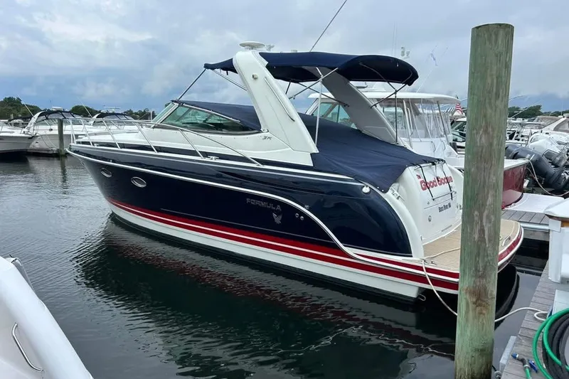 The Image of 2016 Formula 31 Performance Cruiser docked at marina, featuring sleek design and navy blue hull. - 0