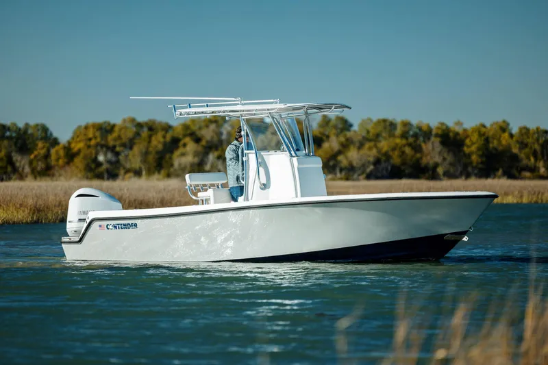 The Image of 2026 Contender 25 Tournament boat cruising on a serene waterway with lush greenery. - 0