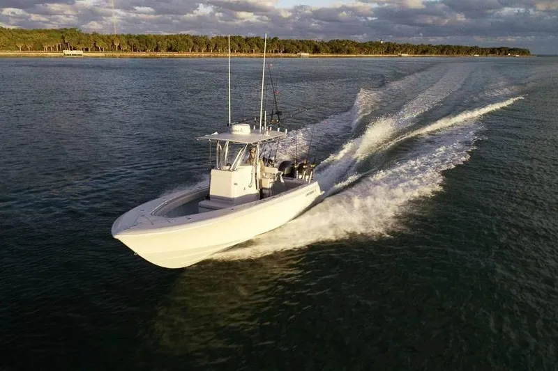 Slide: The Image of 2026 Contender 25 Tournament boat cruising on open water at sunset. - 3