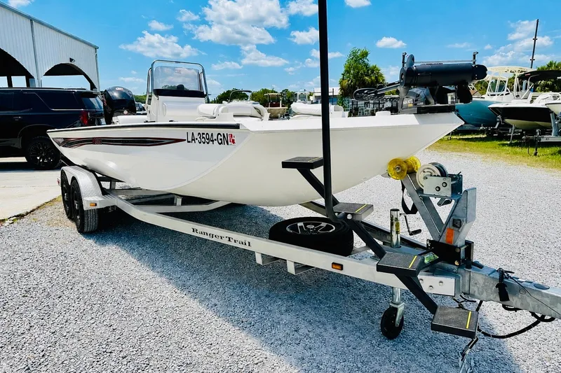 Slide: The Image of 2021 Ranger RB200 boat on trailer, parked outdoors under a clear blue sky. - 6