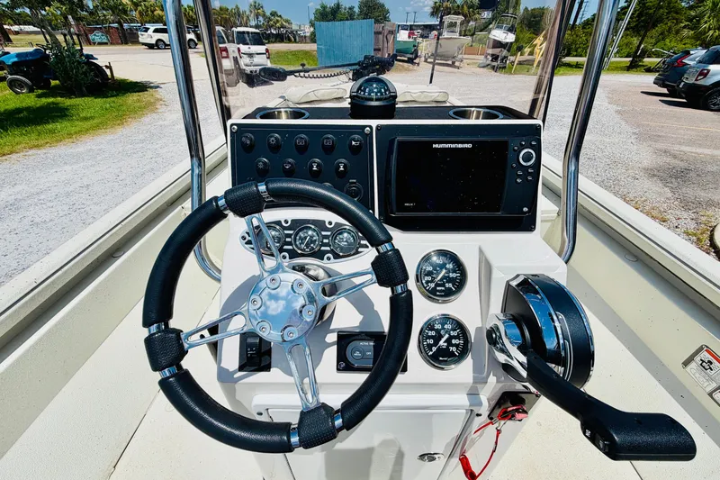 Slide: The Image of Cockpit view of a 2021 Ranger RB200 boat with steering wheel and navigation controls. - 16