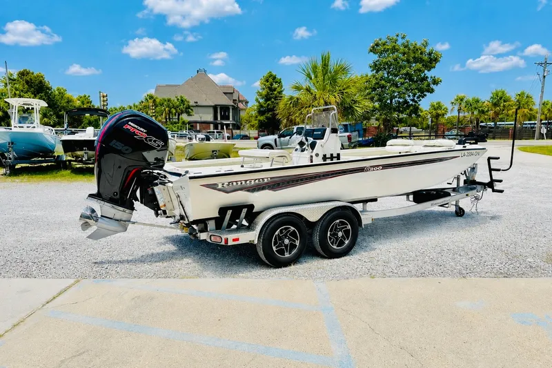 Slide: The Image of 2021 Ranger RB200 boat on trailer, parked outdoors under a clear blue sky. - 4